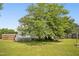 Side view of a home with a wooden fence, deck, and lush green grass at 6521 Cablewood Dr, Raleigh, NC 27603
