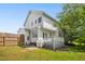 Back exterior of a home with a deck, green grass, and a wooden fence at 6521 Cablewood Dr, Raleigh, NC 27603