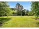 Expansive backyard with lush green grass and a wooden fence under a clear blue sky at 6521 Cablewood Dr, Raleigh, NC 27603