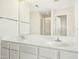 Bathroom with double sinks, a large mirror, and a separate shower at 6521 Cablewood Dr, Raleigh, NC 27603