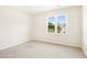 Neutral bedroom with a large window providing natural light at 6521 Cablewood Dr, Raleigh, NC 27603