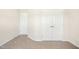 A carpeted bedroom with a double door closet and a single door leading out of the room at 6521 Cablewood Dr, Raleigh, NC 27603