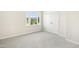 Neutral bedroom with a window providing natural light and a double door closet for storage at 6521 Cablewood Dr, Raleigh, NC 27603