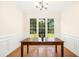 Formal dining room with hardwood floors and paneled walls at 6521 Cablewood Dr, Raleigh, NC 27603