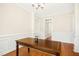 Formal dining room with hardwood floors and paneled walls at 6521 Cablewood Dr, Raleigh, NC 27603