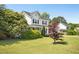 Charming two-story home with a well-manicured lawn and mature landscaping at 6521 Cablewood Dr, Raleigh, NC 27603