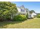 Charming two-story home with a well-manicured lawn and mature landscaping at 6521 Cablewood Dr, Raleigh, NC 27603