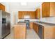 Functional kitchen with stainless steel appliances and neutral countertops at 6521 Cablewood Dr, Raleigh, NC 27603