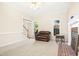Bright living room with fireplace, neutral carpet, and lots of natural light at 6521 Cablewood Dr, Raleigh, NC 27603