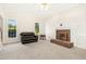Bright living room with fireplace, neutral carpet, and lots of natural light at 6521 Cablewood Dr, Raleigh, NC 27603