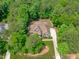 Aerial shot of a craftsman-style home surrounded by lush greenery with a private, fenced backyard at 677 Juliette Ct, Creedmoor, NC 27522