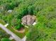 Overhead aerial view of a craftsman style home surrounded by lush green trees in a desirable neighborhood at 677 Juliette Ct, Creedmoor, NC 27522