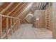 This attic features exposed framing, plywood walls, and plywood flooring at 677 Juliette Ct, Creedmoor, NC 27522