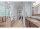 Well-lit bathroom with tiled floors, a glass shower, a soaking tub, and double sink at 677 Juliette Ct, Creedmoor, NC 27522