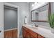 This bathroom has a wood vanity, an oval sink, and a large decorative mirror at 677 Juliette Ct, Creedmoor, NC 27522