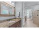 Bathroom features a tiled walk-in shower, granite countertops, and a spacious layout at 677 Juliette Ct, Creedmoor, NC 27522