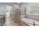 Elegant bathroom featuring a luxurious soaking tub, a glass shower, and granite countertops at 677 Juliette Ct, Creedmoor, NC 27522