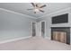 Spacious bedroom with a ceiling fan, fireplace, and neutral carpet providing a comfortable atmosphere at 677 Juliette Ct, Creedmoor, NC 27522