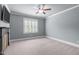 Comfortable bedroom with large window with shutter blinds, ceiling fan, and neutral carpeting at 677 Juliette Ct, Creedmoor, NC 27522
