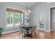 Dining room with natural light, wood floors, and a view into the wooded yard at 677 Juliette Ct, Creedmoor, NC 27522