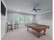 This game room has great natural light, a billiard table, and trim work along the wall at 677 Juliette Ct, Creedmoor, NC 27522