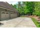 Spacious three car garage with a concrete driveway and a view of the fenced-in backyard at 677 Juliette Ct, Creedmoor, NC 27522