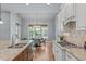 Kitchen with granite counters, island, stainless appliances, and eat-in dining area at 677 Juliette Ct, Creedmoor, NC 27522