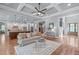 Open-concept living room with hardwood floors, coffered ceilings, and seamless flow into the kitchen at 677 Juliette Ct, Creedmoor, NC 27522