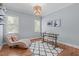 Home office with hardwood floors, modern desk, and relaxing chaise lounge by a bright window at 677 Juliette Ct, Creedmoor, NC 27522