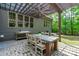 Inviting outdoor dining area under a pergola, perfect for backyard gatherings at 677 Juliette Ct, Creedmoor, NC 27522