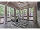 Relaxing screened porch with decorative elements, comfortable seating, and wooded views at 677 Juliette Ct, Creedmoor, NC 27522