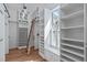 Bright walk-in closet with ample shelving, natural light, and a charming rolling ladder at 677 Juliette Ct, Creedmoor, NC 27522