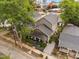 Aerial view of a home with gray siding, shingle detail, covered porch, and beautiful yard at 711 Hinsdale St, Raleigh, NC 27605