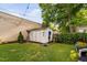 Backyard featuring a storage shed, well-kept lawn, and tasteful landscaping at 711 Hinsdale St, Raleigh, NC 27605
