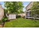 Backyard featuring a storage shed, well-kept lawn, screened in porch, and tasteful landscaping at 711 Hinsdale St, Raleigh, NC 27605
