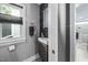 Stylish half bathroom featuring modern vanity, stone accent wall, and natural light at 711 Hinsdale St, Raleigh, NC 27605