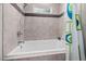 Clean bathroom featuring a shower and tub combo with tiled walls and bright, natural light at 711 Hinsdale St, Raleigh, NC 27605