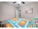 Cozy bedroom featuring a ceiling fan, neutral walls, and colorful bedding for a vibrant, inviting space at 711 Hinsdale St, Raleigh, NC 27605