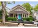 Charming home with gray siding, shingle detail, blue door, and well-manicured landscaping at 711 Hinsdale St, Raleigh, NC 27605