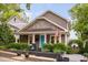 Charming home with gray siding, shingle detail, blue door, and front yard landscaping at 711 Hinsdale St, Raleigh, NC 27605