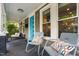 Inviting front porch with colorful door, stylish seating, and charming architectural details at 711 Hinsdale St, Raleigh, NC 27605