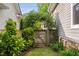 Charming garden gate with flowering vines and lush greenery creating a private entry at 711 Hinsdale St, Raleigh, NC 27605