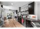 Open concept kitchen with stainless steel appliances, light hardwood floors, and adjacent breakfast nook at 711 Hinsdale St, Raleigh, NC 27605
