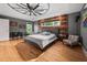 Spacious main bedroom with wood accent wall, modern ceiling fan, and hardwood floors at 711 Hinsdale St, Raleigh, NC 27605