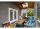 Cozy screened porch with comfortable seating, wooden ceiling, and bright, natural light at 711 Hinsdale St, Raleigh, NC 27605