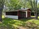 Detached garage features a screened in area for leisure activities at 727 Queens Ave, Dunn, NC 28334