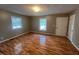 Bright bedroom featuring wood flooring and natural light from two windows at 727 Queens Ave, Dunn, NC 28334
