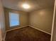 A cozy bedroom features neutral walls, plush carpeting, and a bright window at 727 Queens Ave, Dunn, NC 28334