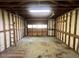 Interior of the garage with exposed framing and roll-up door at 727 Queens Ave, Dunn, NC 28334