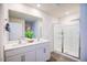 Bright bathroom with double sink vanity, large mirror, and a glass-enclosed shower at 7461 Michelle Rd, Rocky Mount, NC 27803